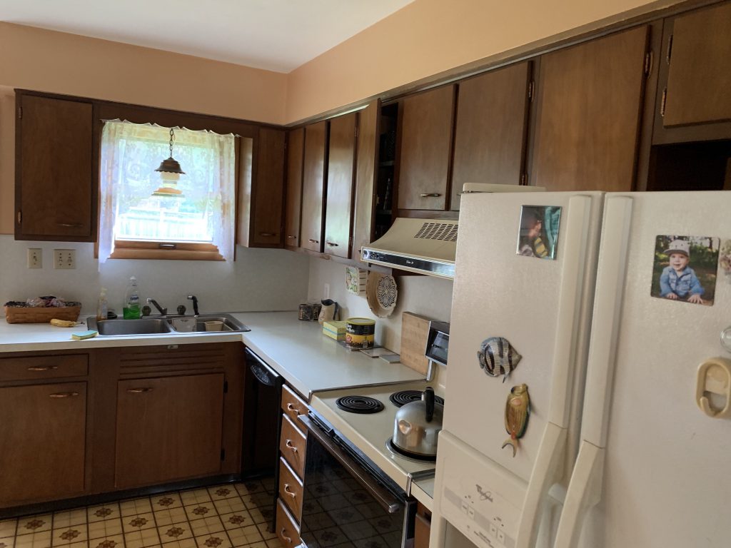 Revitalizing Neighborhoods, One House At A Time 4 Inside of a home with a refrigerator.