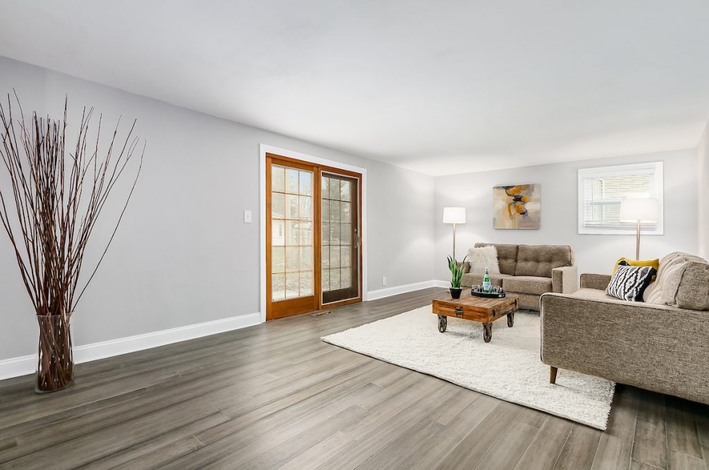 Revitalizing Neighborhoods, One House At A Time 17 A living room with sliding doors.