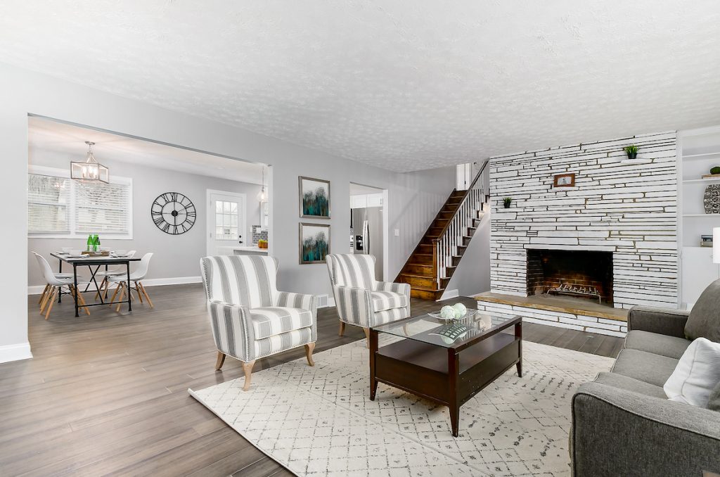 Revitalizing Neighborhoods, One House At A Time 14 A living room that opens up to a dining area.