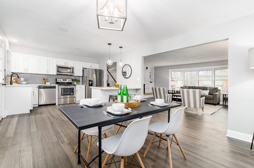 Revitalizing Neighborhoods, One House At A Time 8 A kitchen with stainless steel appliances and a kitchen table.