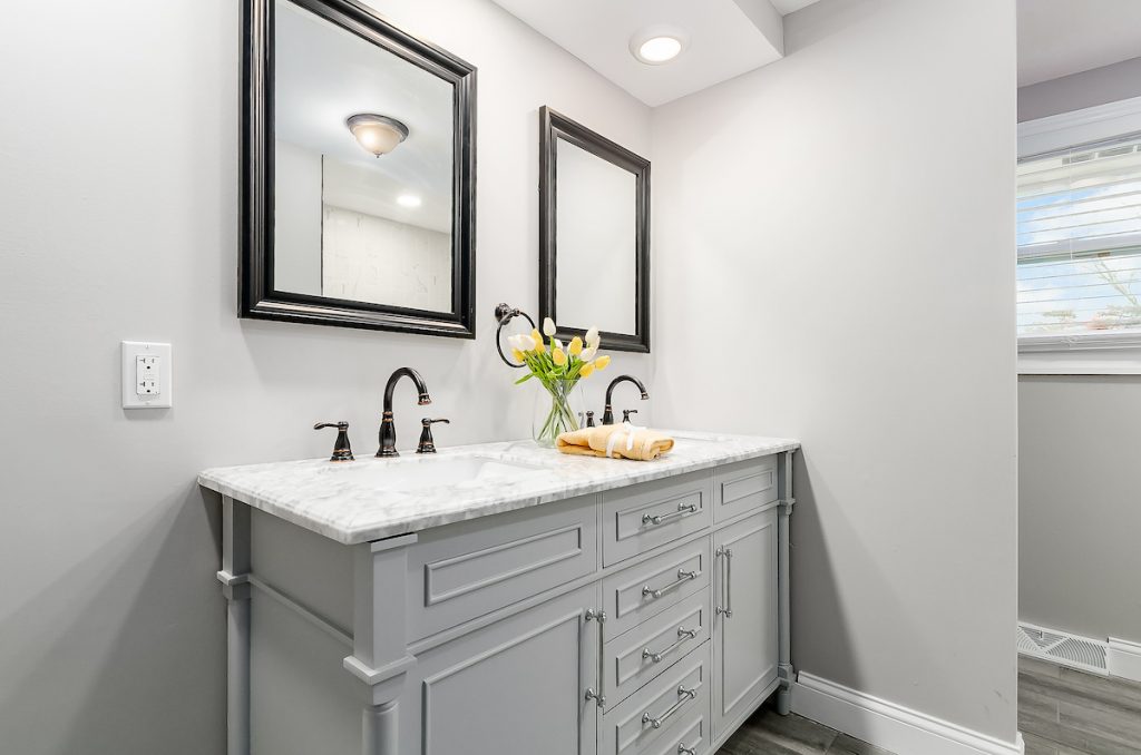 Revitalizing Neighborhoods, One House At A Time 10 A double vanity sink with two mirrors above each sink.