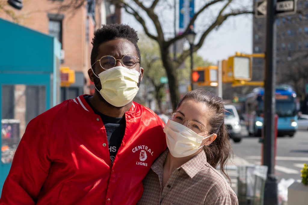 Moving to the Suburbs During COVID: 3 Benefits of the 2021 Quick Sale 2 A couple with masks pose for a picture before moving out of the city during COVID.