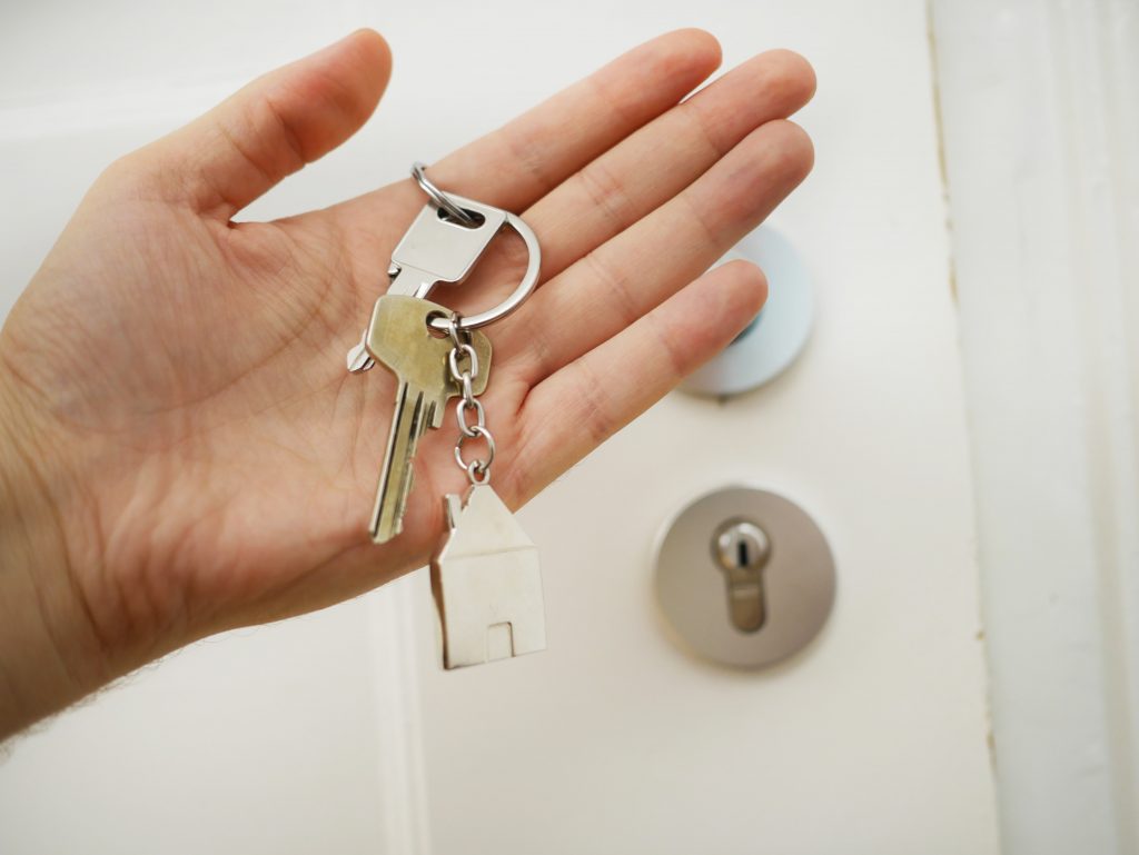 3 Myths of a "Cash for Keys" Agreement 4 A hand holding a set of house keys with a house-shaped key ring attached.